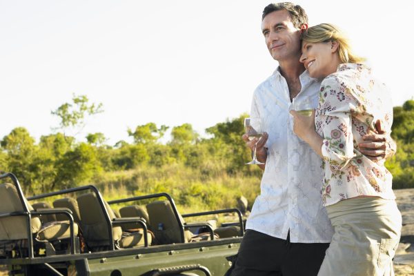 Couple embracing holding wineglasses