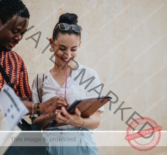 Business colleagues collaborating in an urban city environment, smiling and reviewing work on a tablet together.