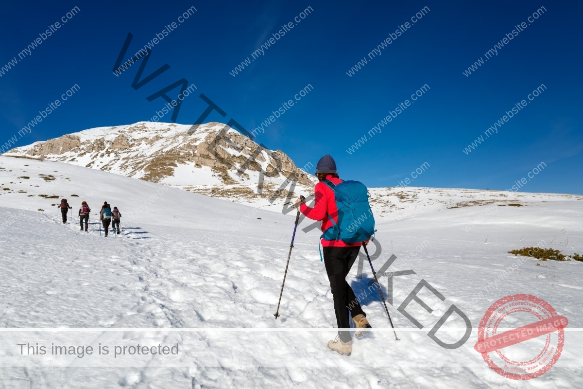 a-woman-walking-on-the-snow-in-the-mountains-2025-01-09-06-23-16-utc
